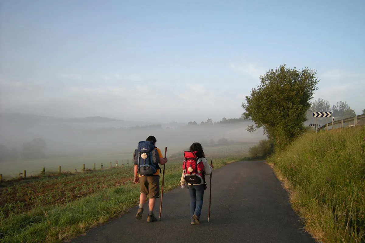 Two pilgrims walking together on the Camino de Santiago.