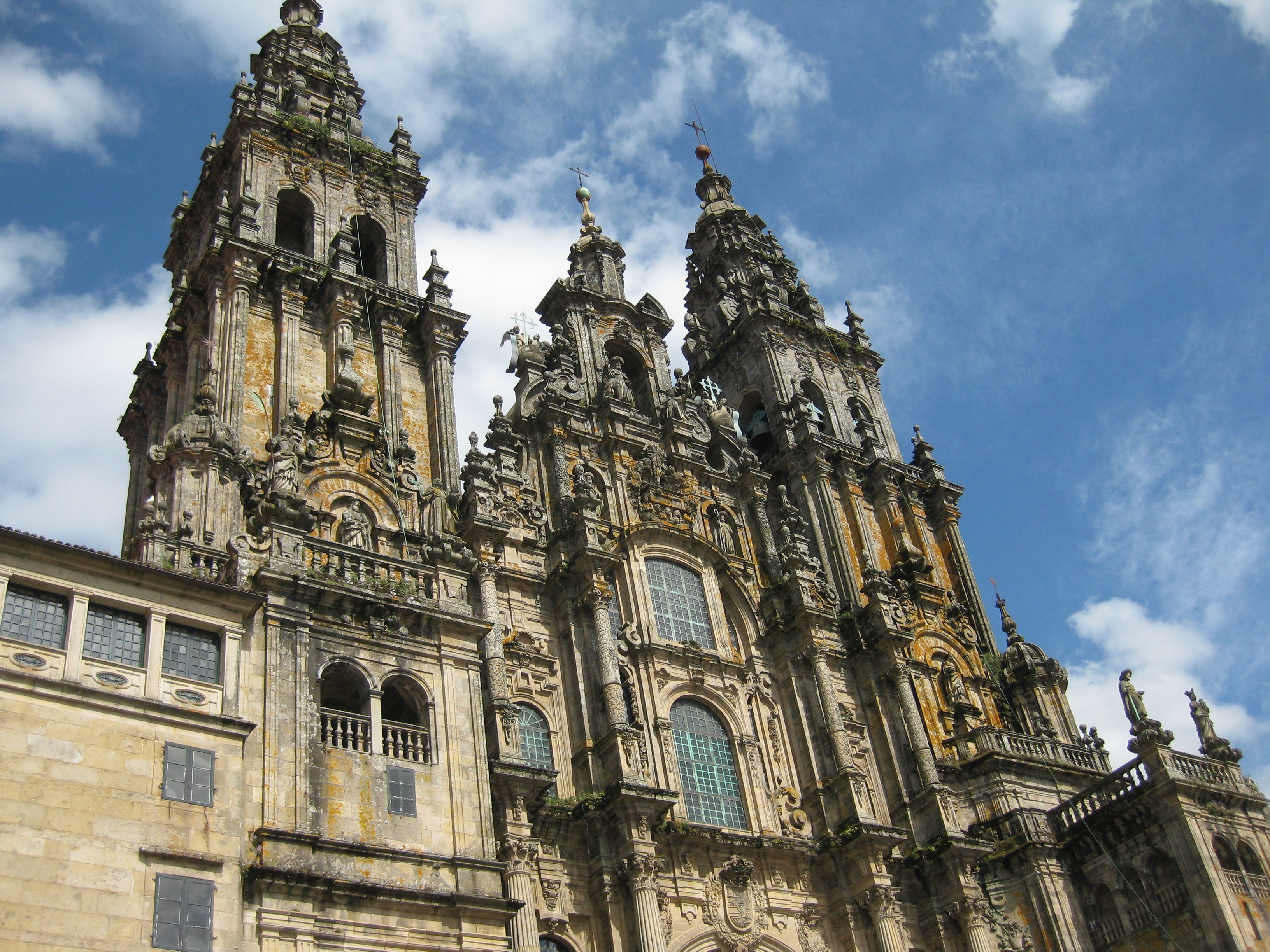 The towers of Santiago de Compostela Cathedral beneath a bright blue sky.