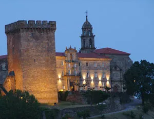 The hilltop fortress and historic Parador of Monforte de Lemos illuminated at dusk.