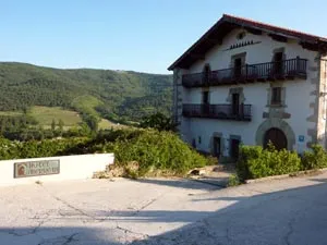 A welcoming Camino hotel in a green mountain landscape.