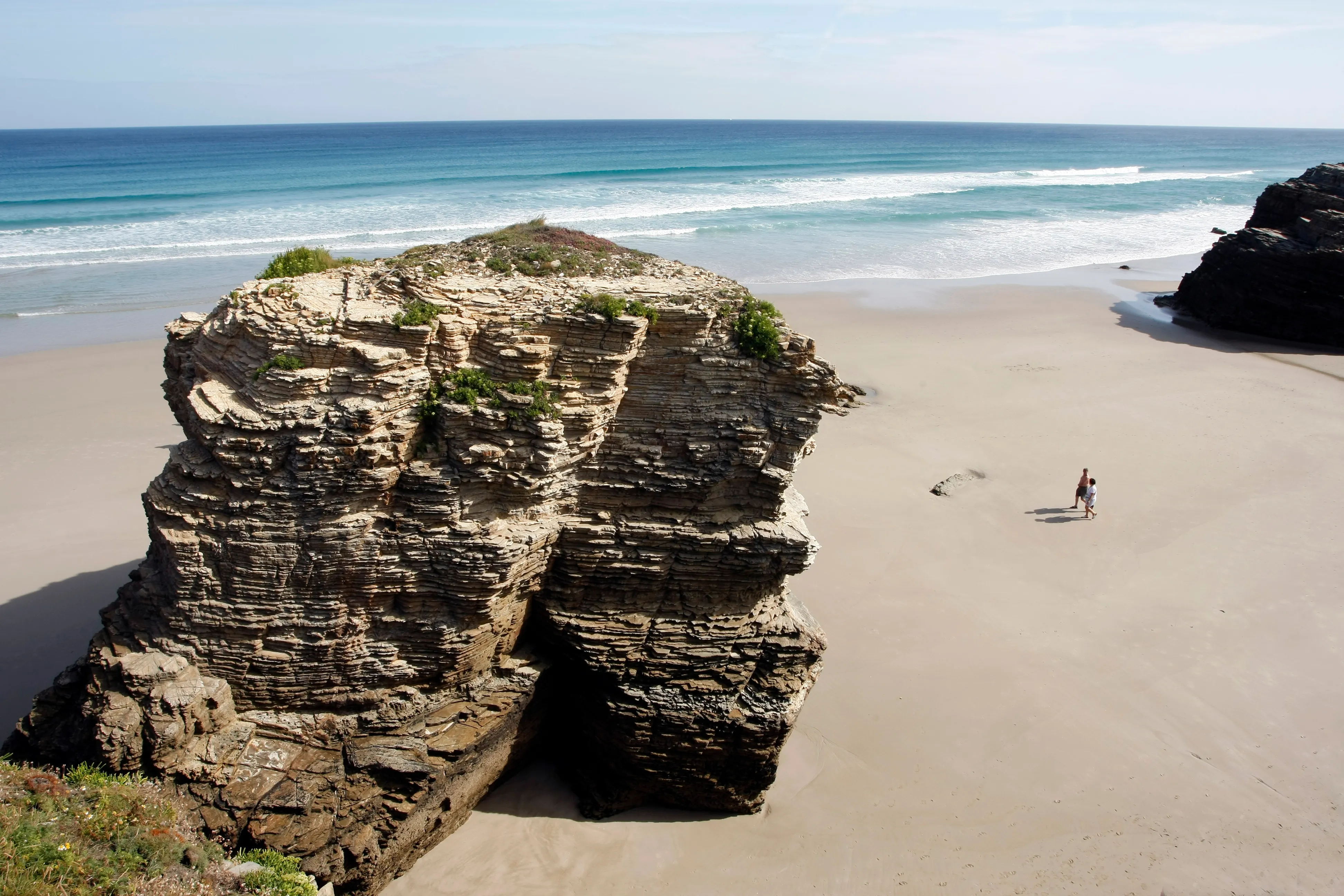 Rock arches and wet sand at Praia das Catedrais on the Galician coast.