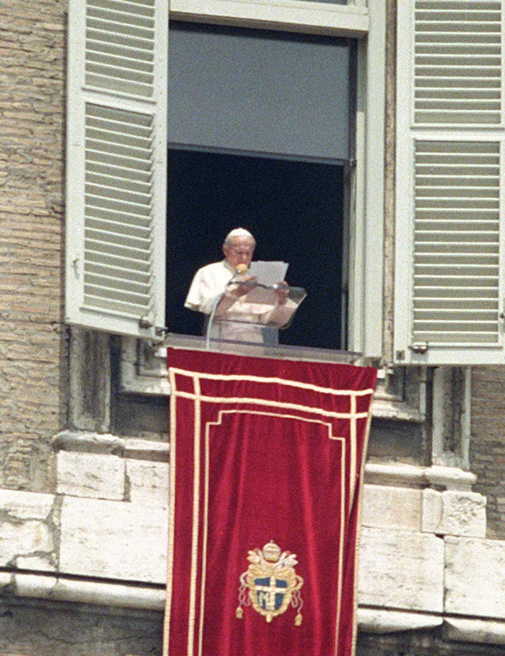 Pope John Paul II speaking from a window at the Vatican in 1984.