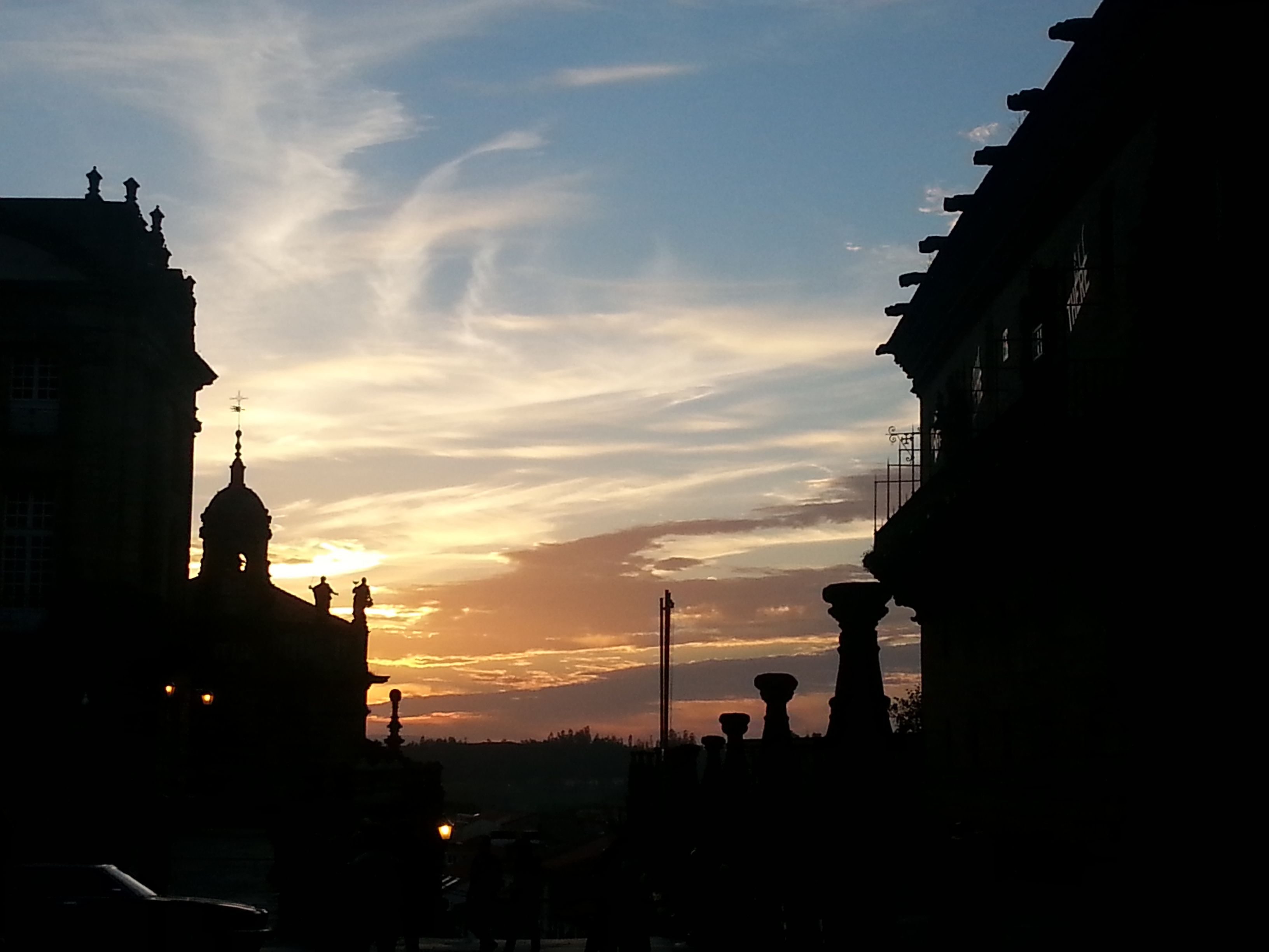Santiago de Compostela silhouetted against the evening sky.