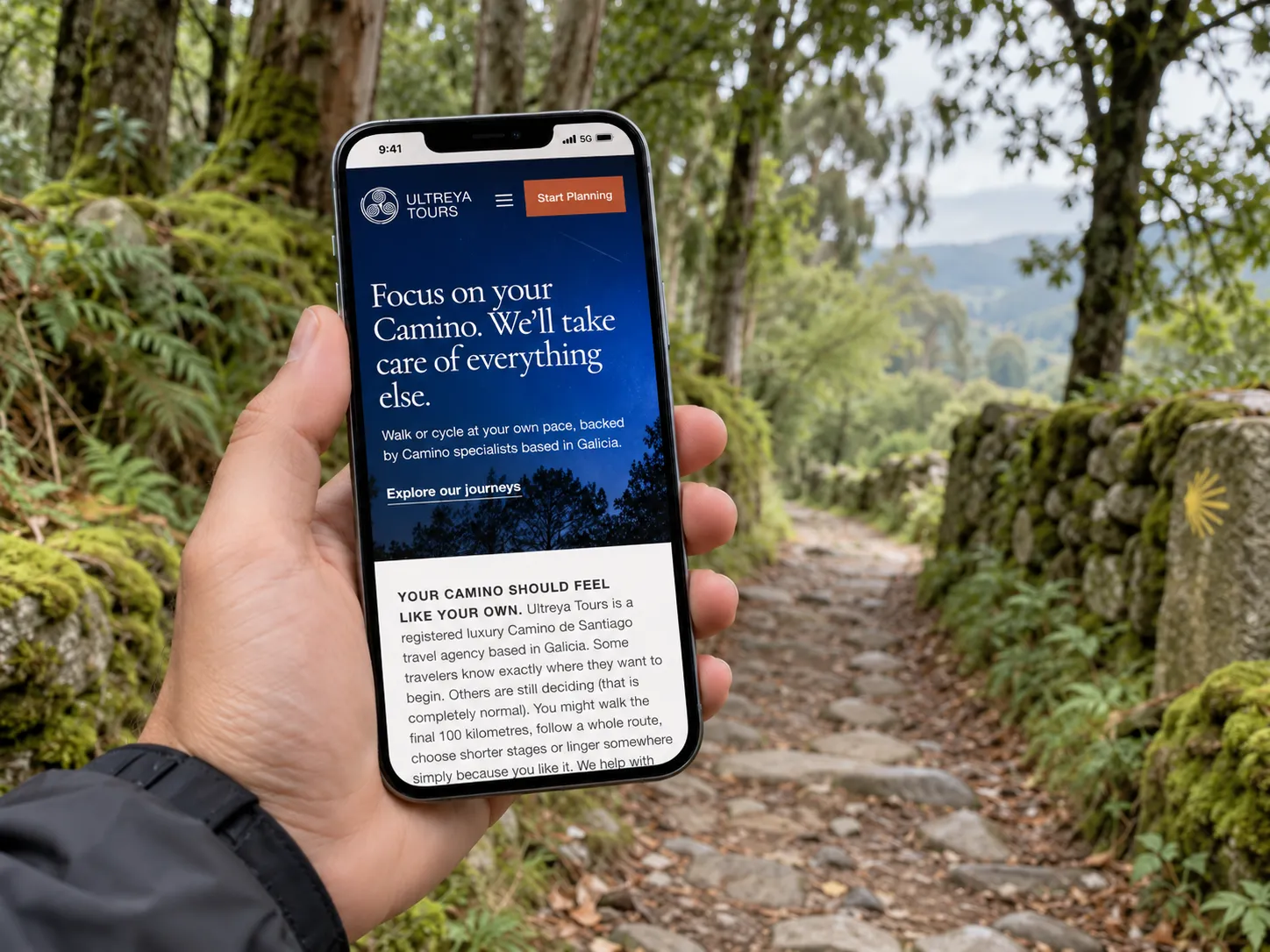 An iPhone displaying the real Ultreya Tours website beside a Camino path in a green forest.