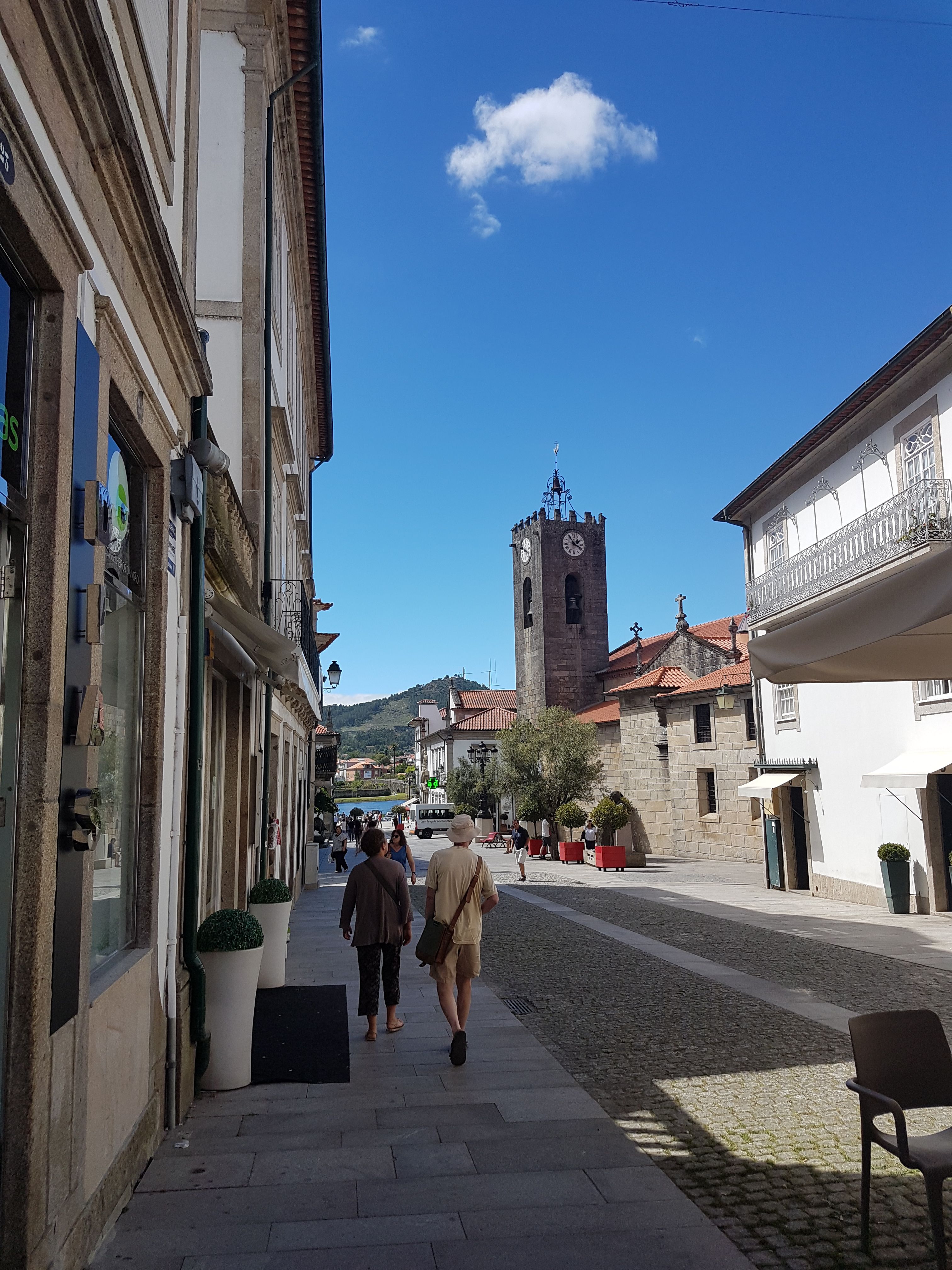 A historic street and church tower on the Portuguese Way.