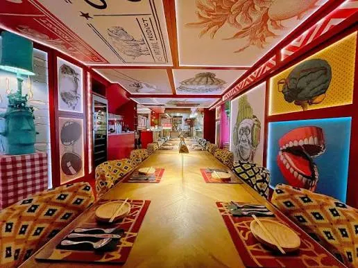 The colourful communal dining room and open counter at Casa Marcelo in Santiago.